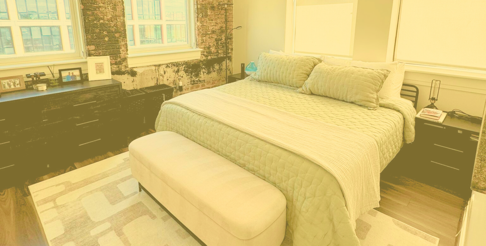 Freshly cleaned bedroom in a Washington DC apartment with natural light, modern furniture, and spotless linens – KAMY House Cleaning Services